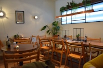 Cozy cafe interior with wooden tables and South Indian decor elements.