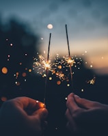 person holding fire cracker shallow focus photography