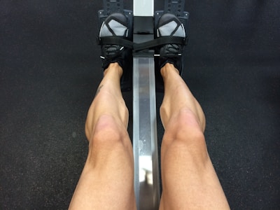 person sitting on rowing machine