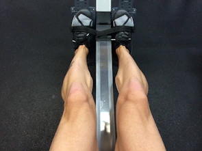 Close-up of a person using a foam roller on their leg after workout.