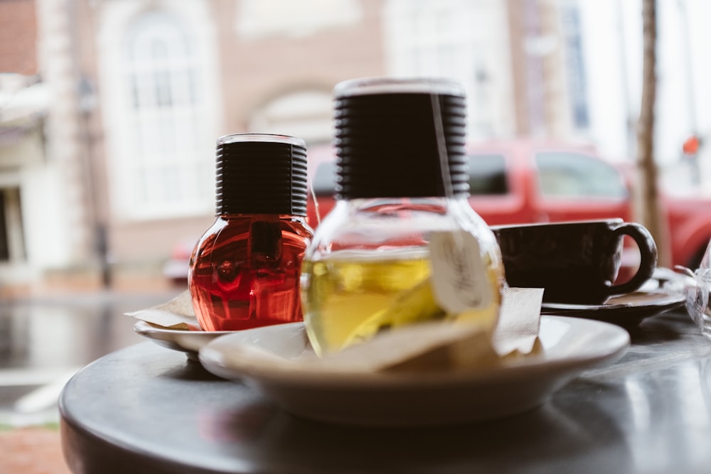 red glass bottle on white ceramic plate