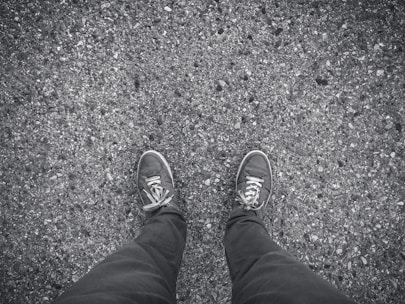 Close-up of a runner's feet hitting the asphalt in the city, without brand logos.
