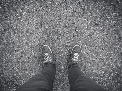 Sneakers with a rugged, streetwise look on cracked pavement
