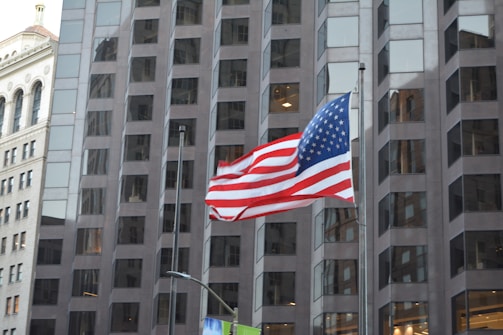 Government building with American flag waving in front.
