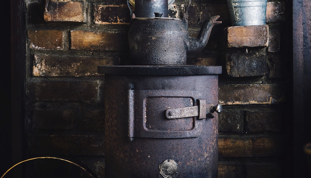 cast-iron teapot on wood burner