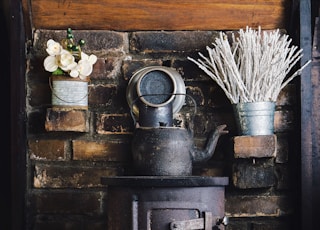 cast-iron teapot on wood burner