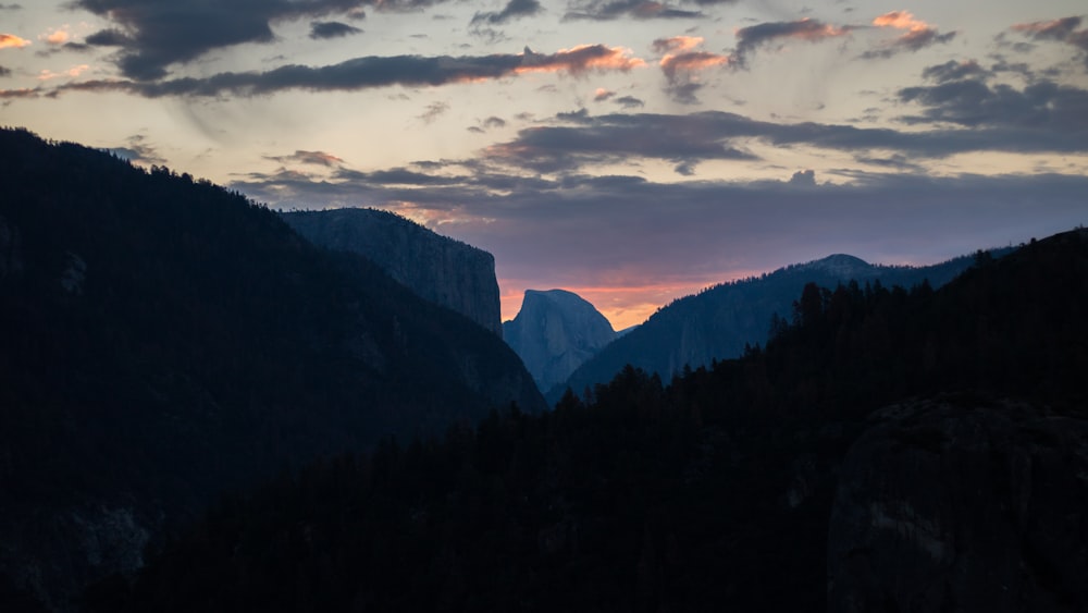 silhouette photo of mountains at sunset