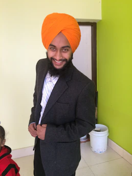 A confident insurance advisor Arun consulting with a smiling Indian family in a bright, modern office.