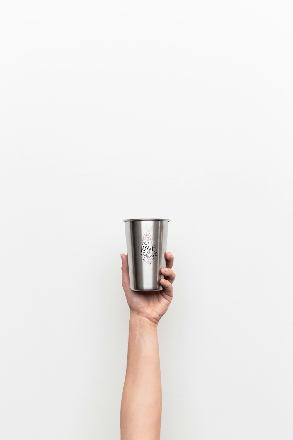person holding gray stainless steel drinking cup