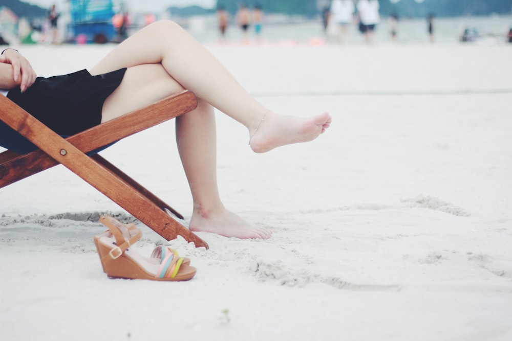 person seats on brown folding chair during daytime