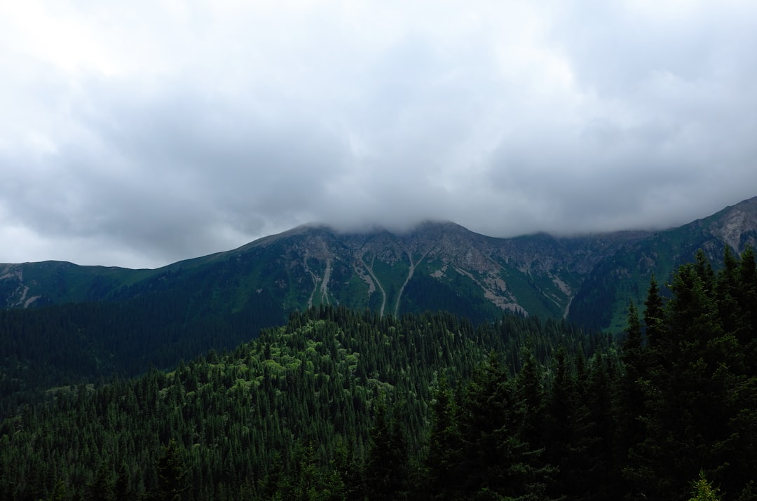 mountains under cloudy skies at daytime
