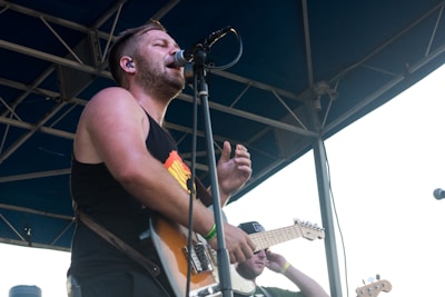 Musician wearing Dreamfit monitors while performing on stage.