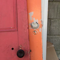 Close-up of a red-painted door inviting curiosity.