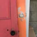 Close-up of a repaired wooden door frame with fresh paint.