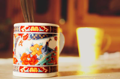 Close-up of colorful, handcrafted ceramic mugs with soft pastel tones