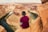 man sitting on brown mountain located at Grand Canyon during daytime