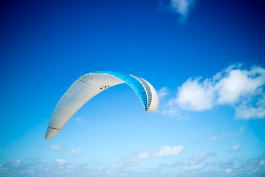 blue and white paragliding in Dune du Pilat France