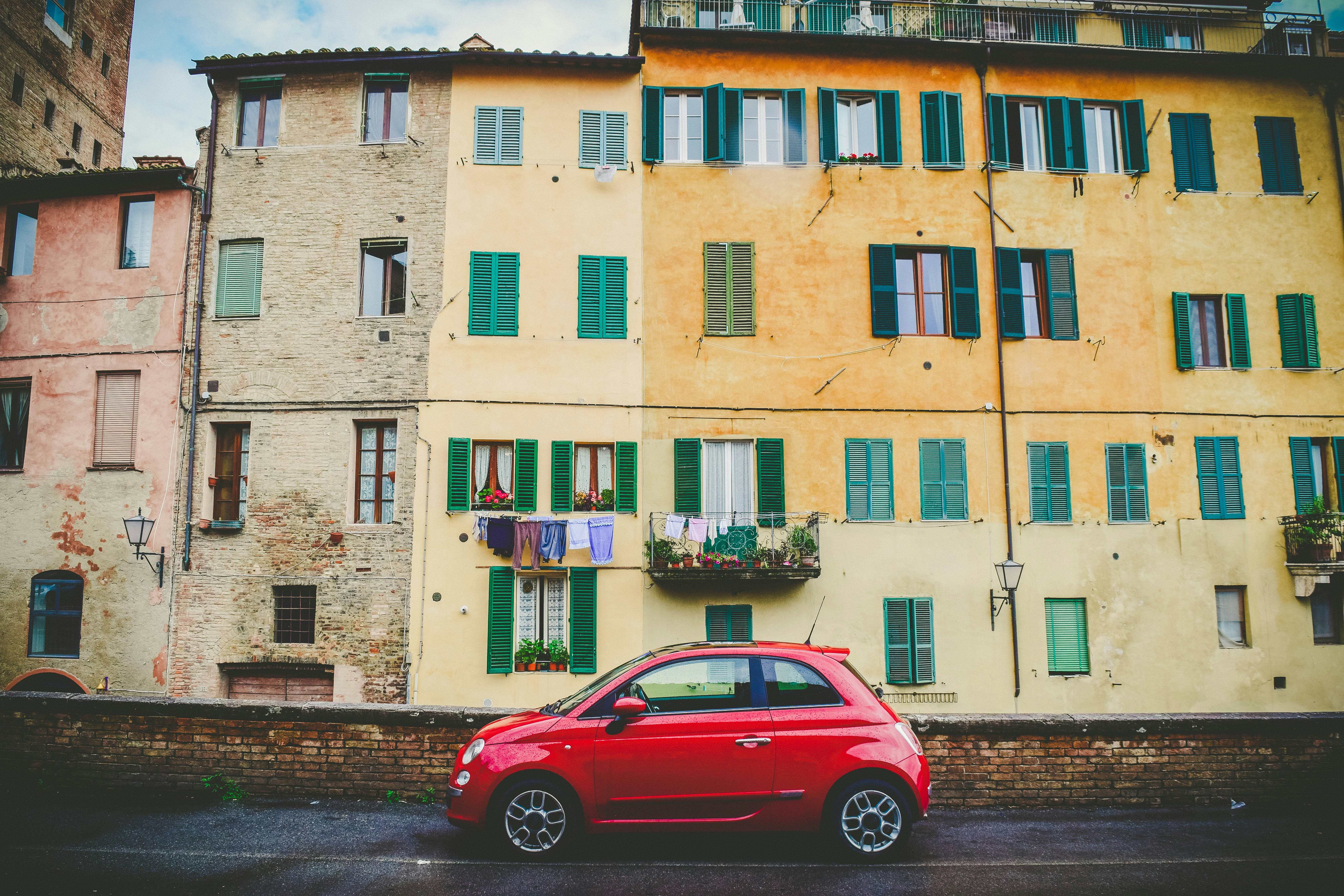 red car yellow buildings