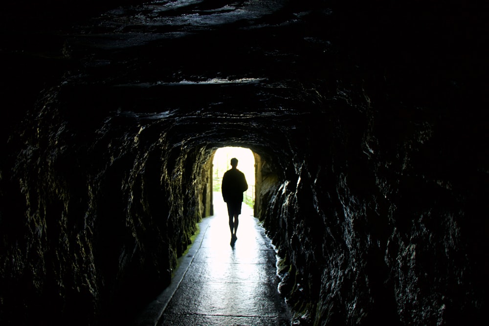 person walking on tunnel during daytime