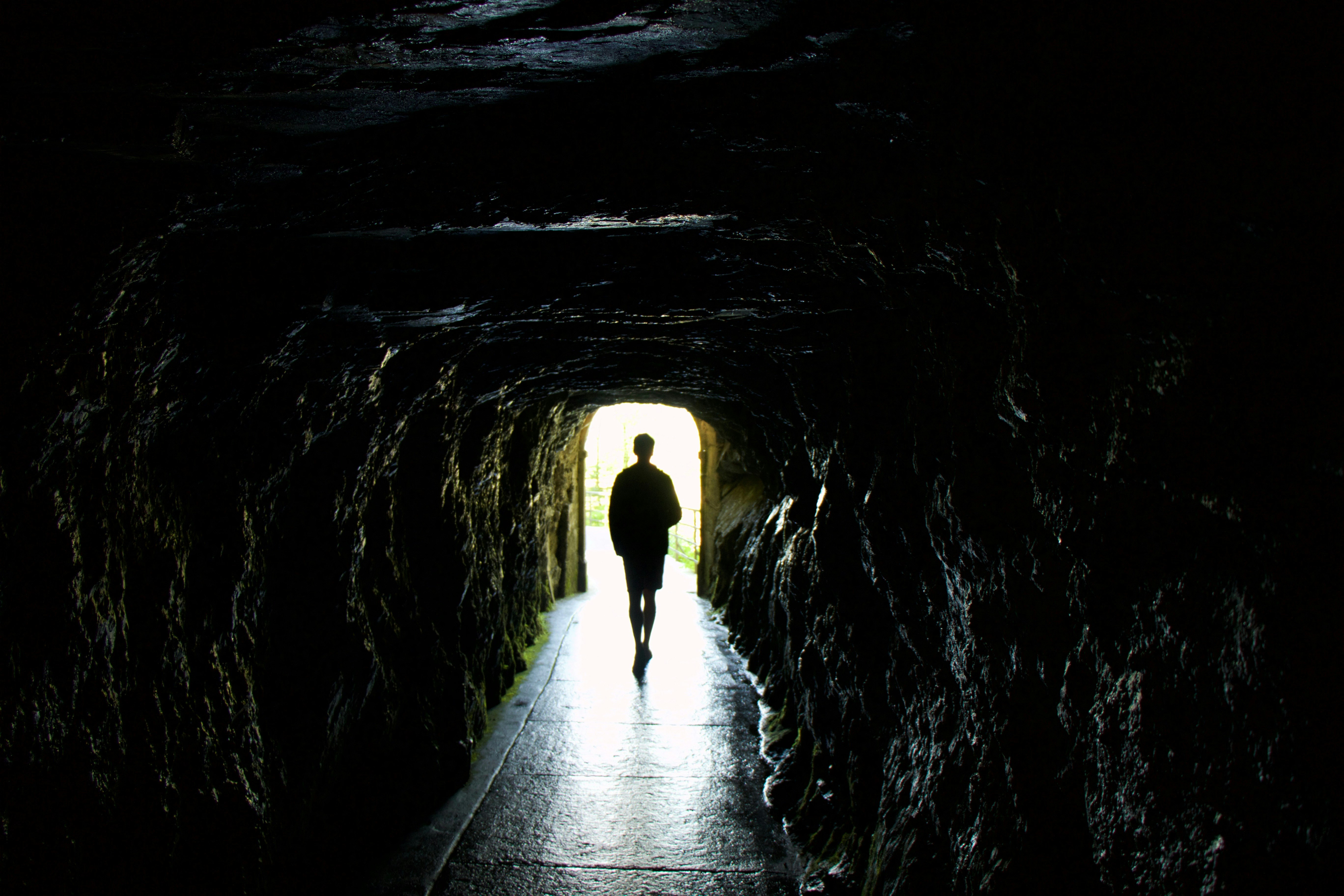 person walking on tunnel during daytime