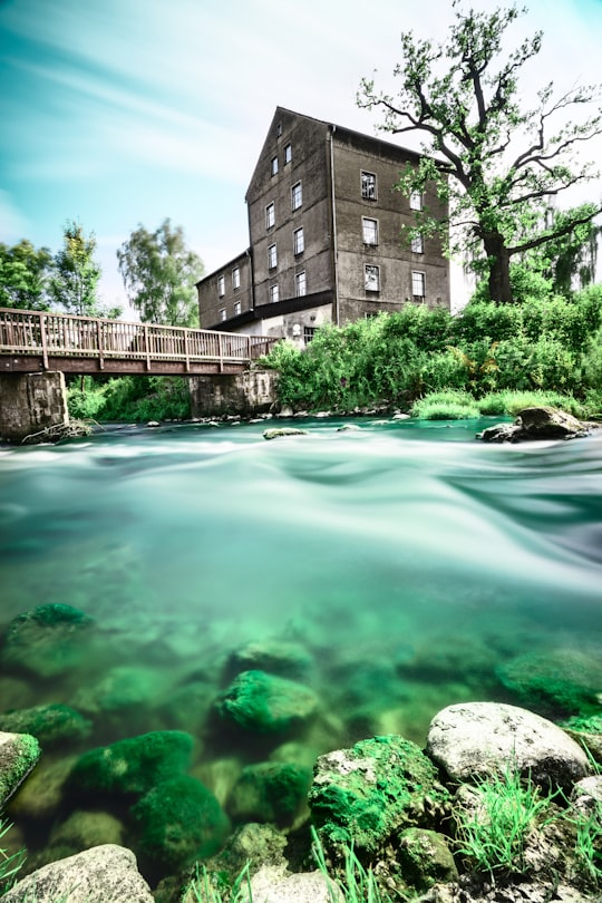 green water fountain near brown concrete building during daytime in Kirchlengern Germany