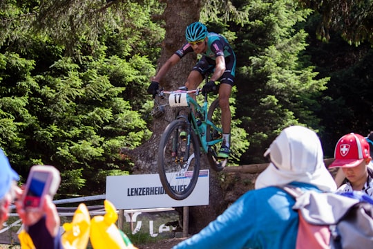 cyclist riding mountain bike jumping over obstackle in Lenzerheide Switzerland