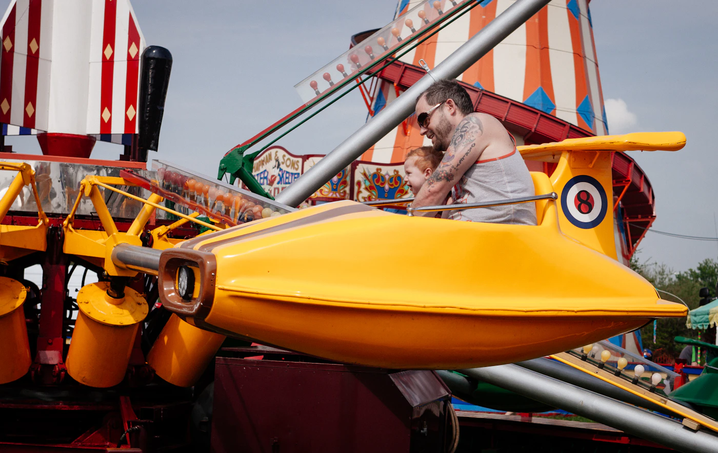 A parent and child sharing an amusement ride