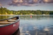 red canoe boat on body of water