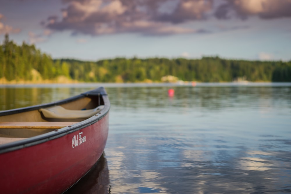 red canoe boat on body of water photo â€