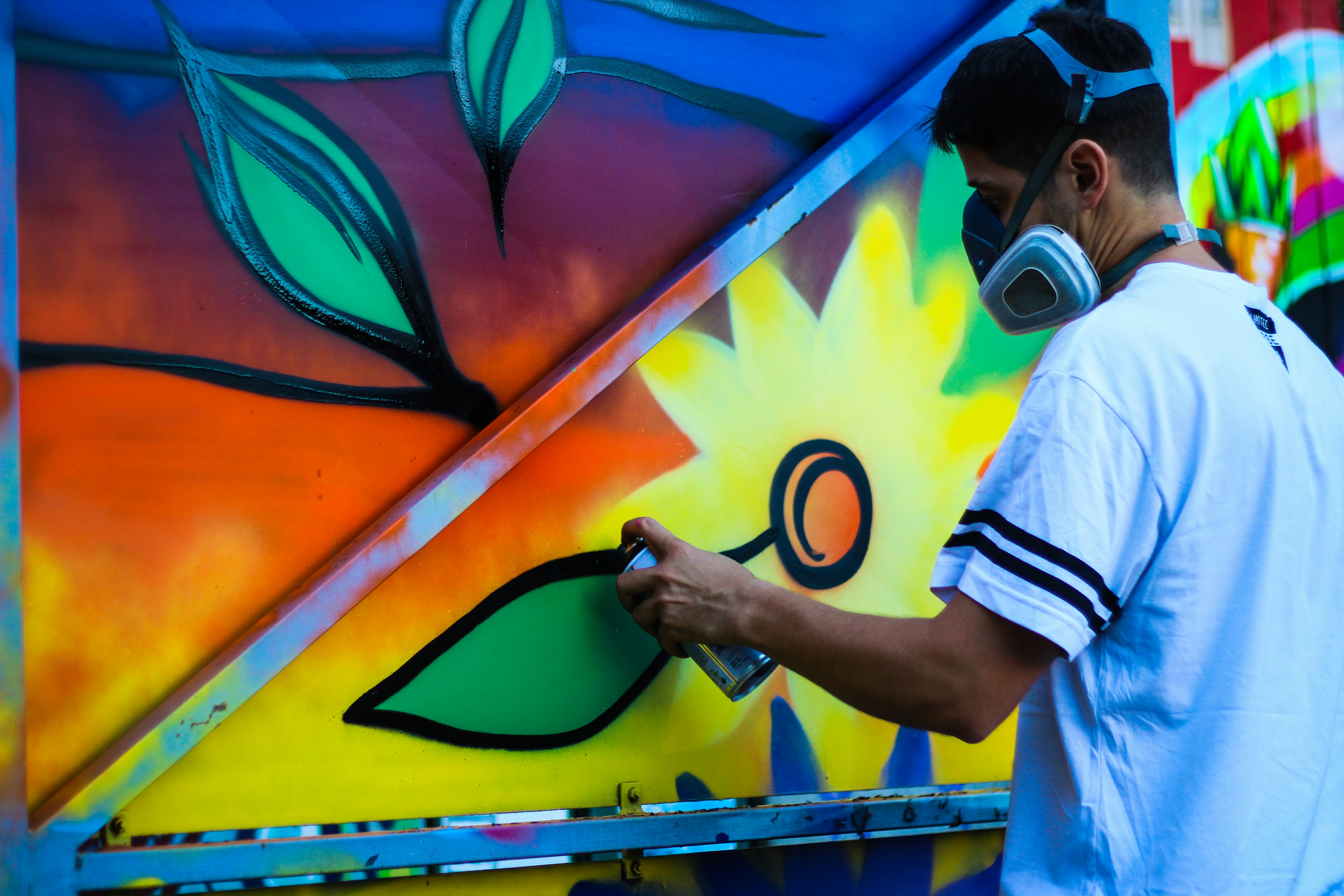 man paint flower on wall