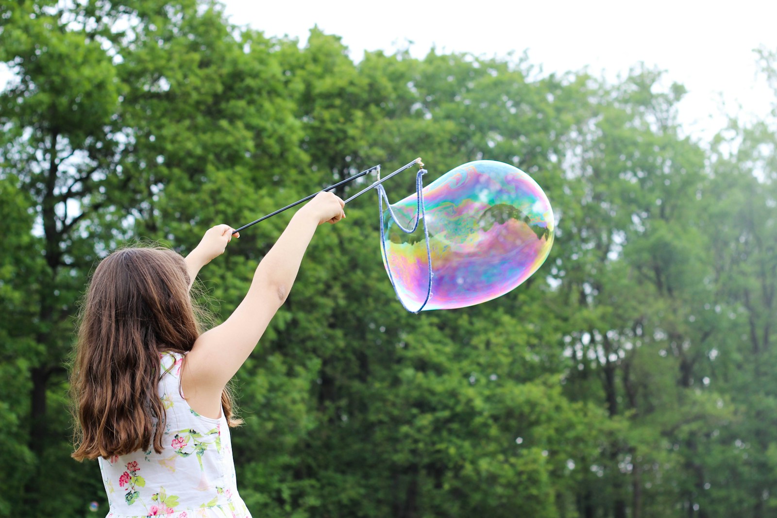 a child playing with bubbles at The Warwick, Maple Ridge townhomes
