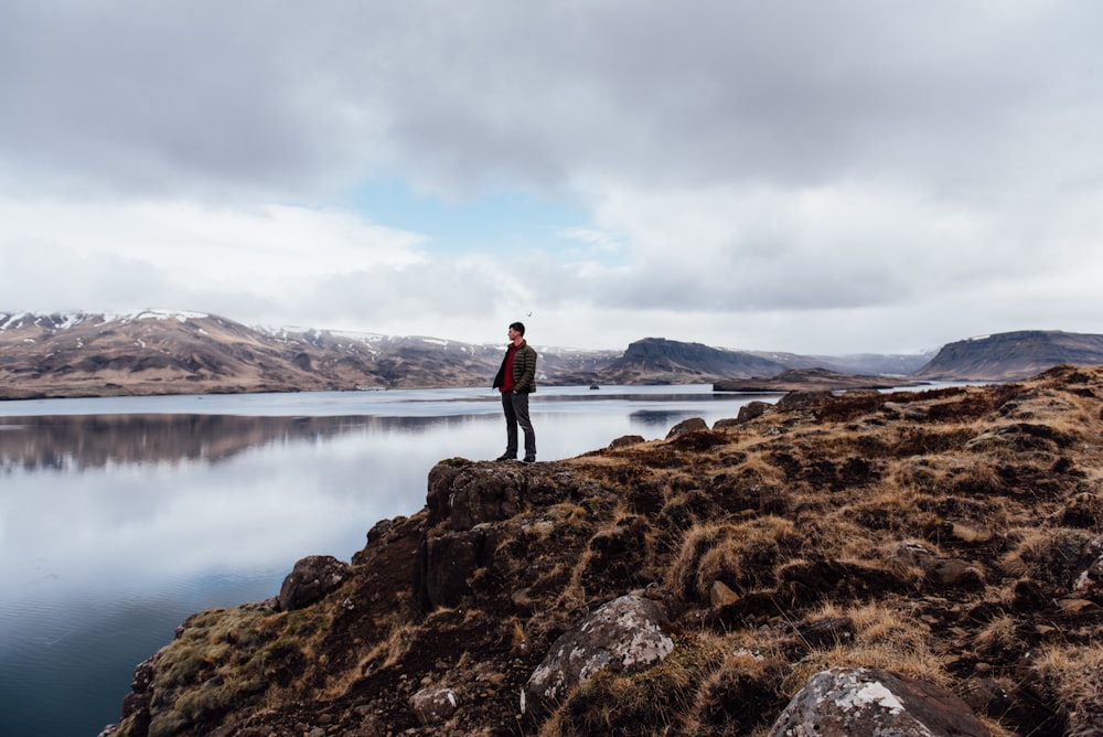 man standing near body of water