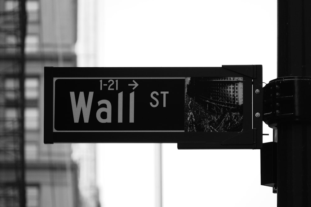 grayscale photo of Wall St. signage