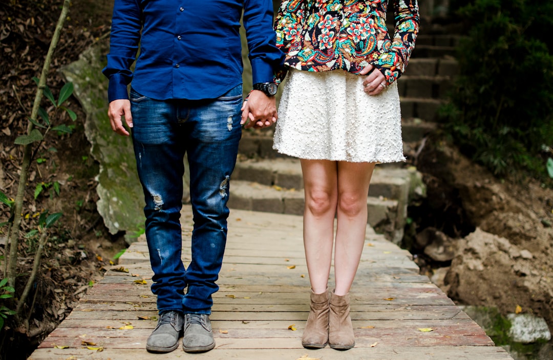 man and woman holding hands during daytime