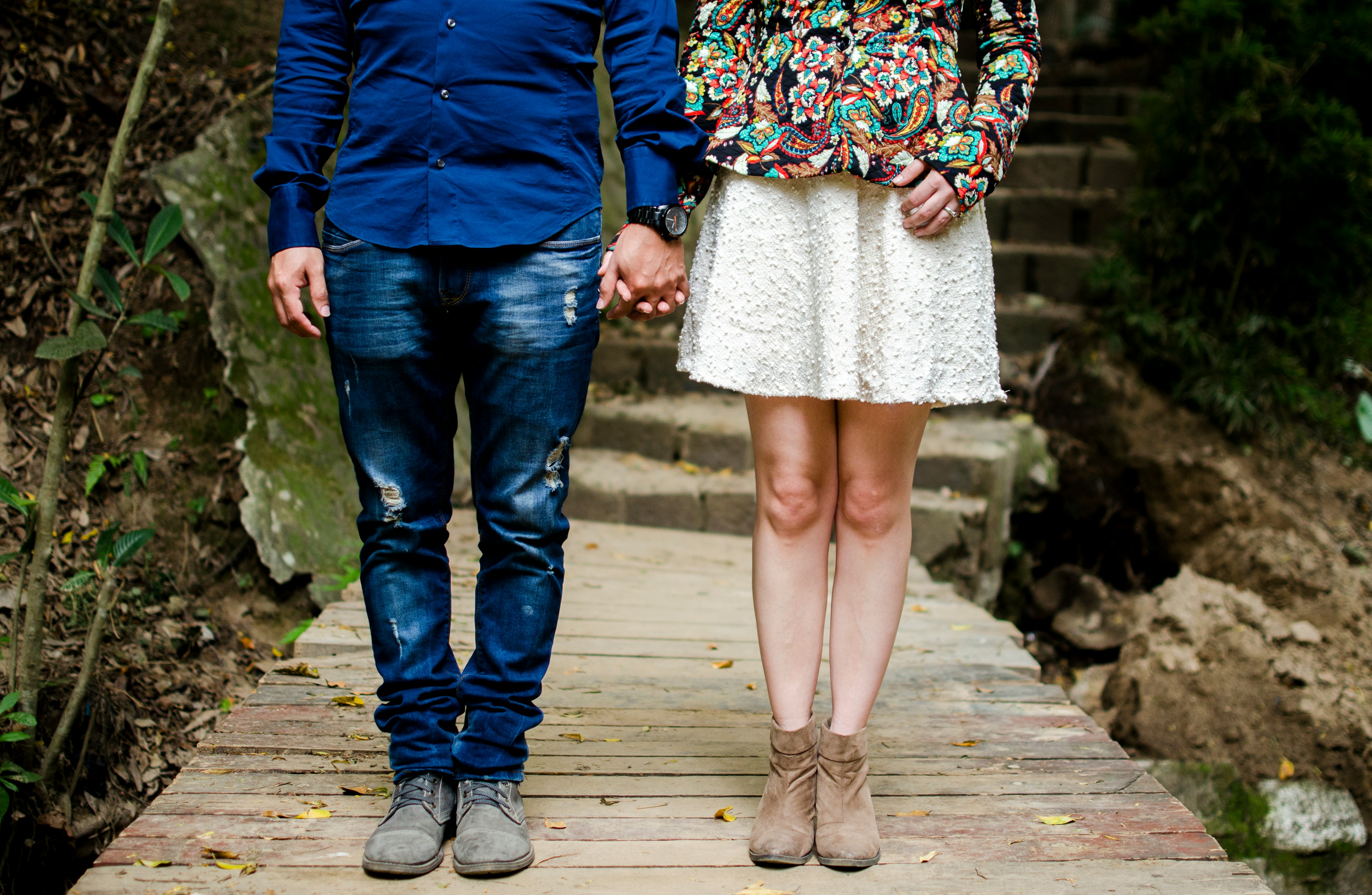 man and woman holding hands during daytime