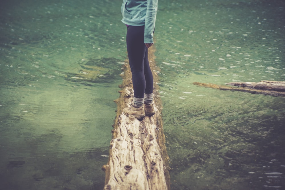 woman standing on log