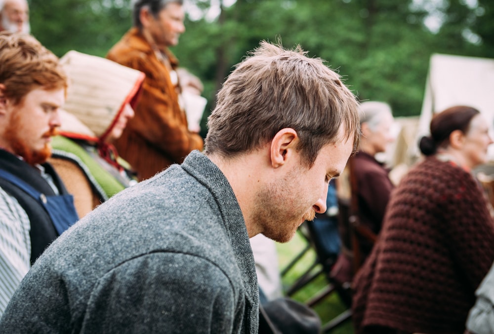 man sitting on chair near people sitting on chair during daytime