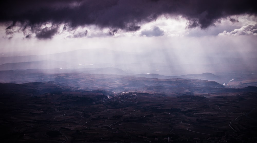 aerial view photography of mountain under cloudy sky