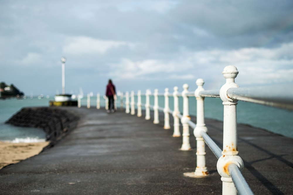 shallow focus photography of man near shore during daytime