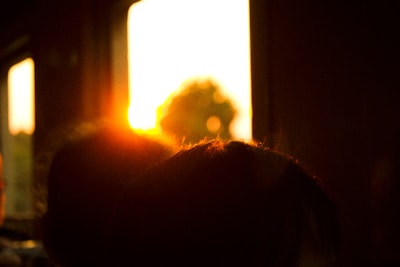 A sunset view through the kitchen window, casting warm light on a pot of simmering stew.