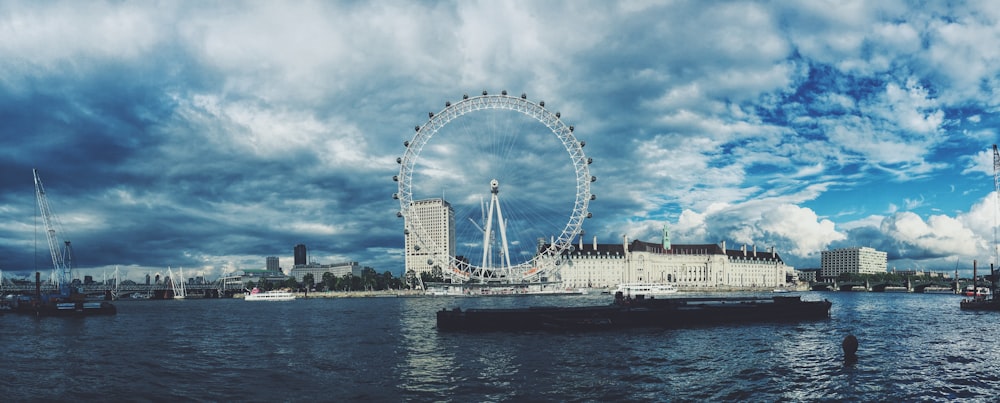 昼間の白い曇り空の下でのロンドンアイのスカイライン写真