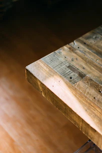 Close-up of a vibrant patterned tablecloth draped elegantly over a rustic wooden table.