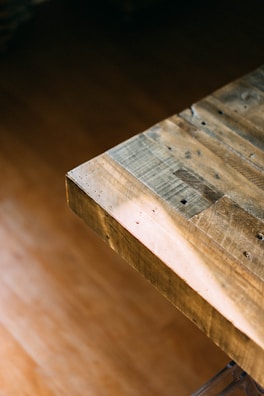 Close-up of a wooden table showcasing natural grain and smooth finish.