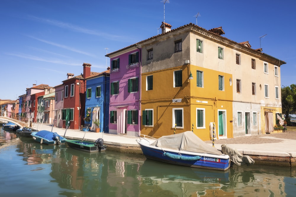 boats near concrete building during daytime