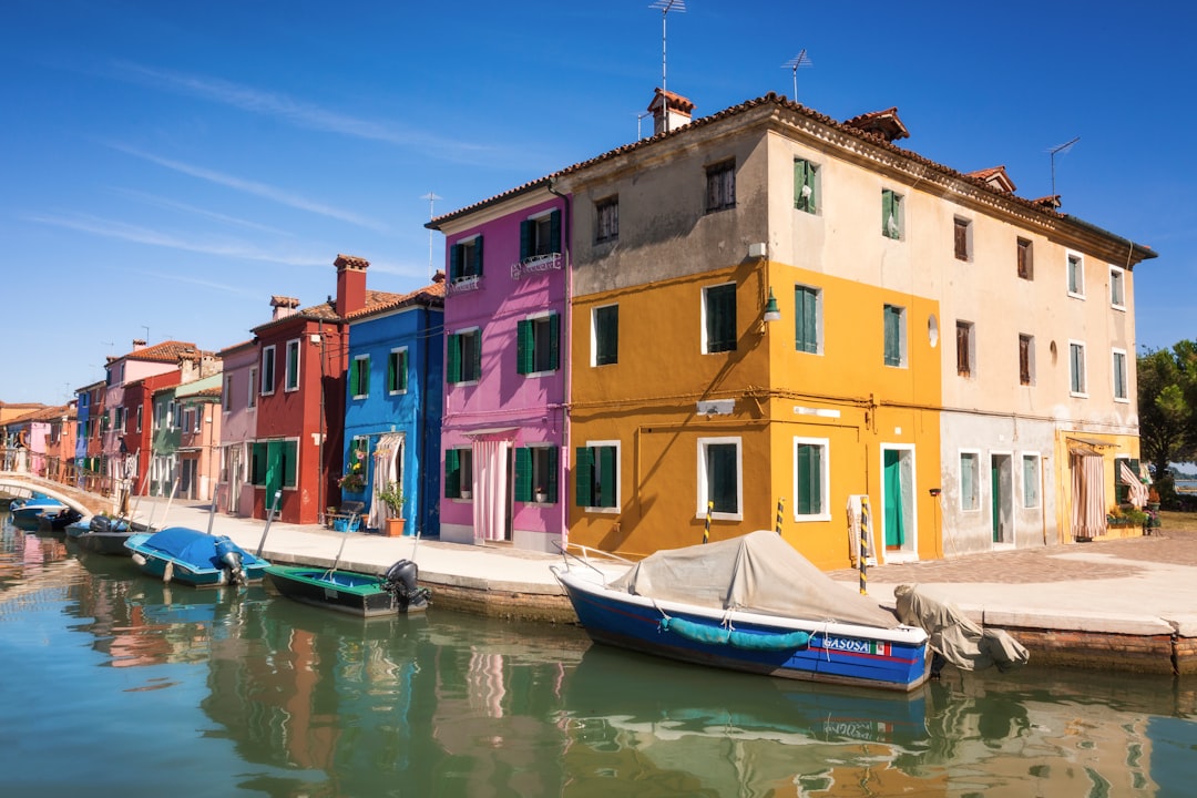 boats near concrete building during daytime,
