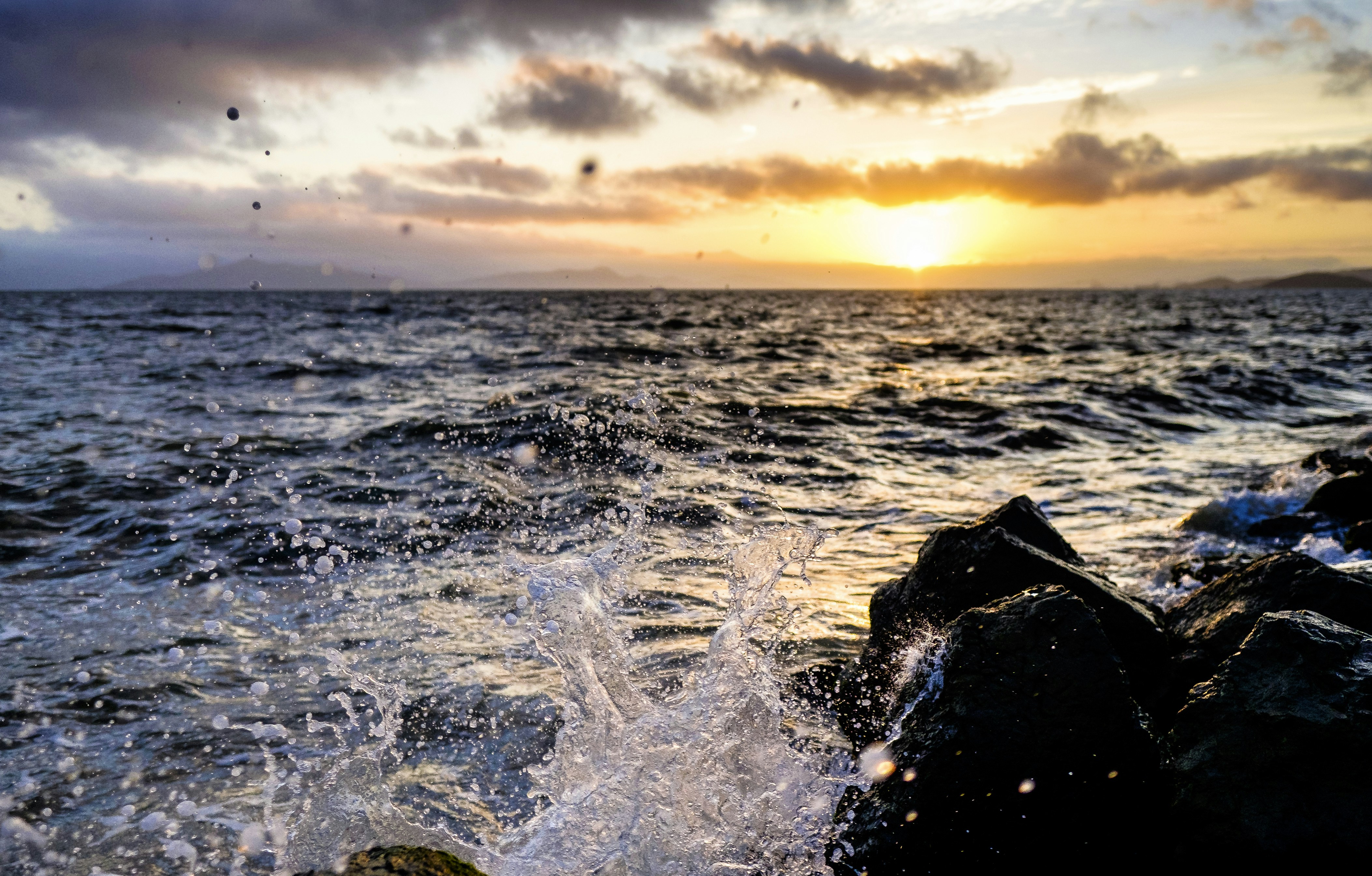 shallow focus photography of seashore with waves under orange sunset, 