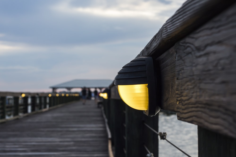 wooden dock with lights turned on at night