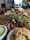 Close-up of a colorful Moroccan lunch plate with fresh salad and traditional bread on a rustic wooden table.