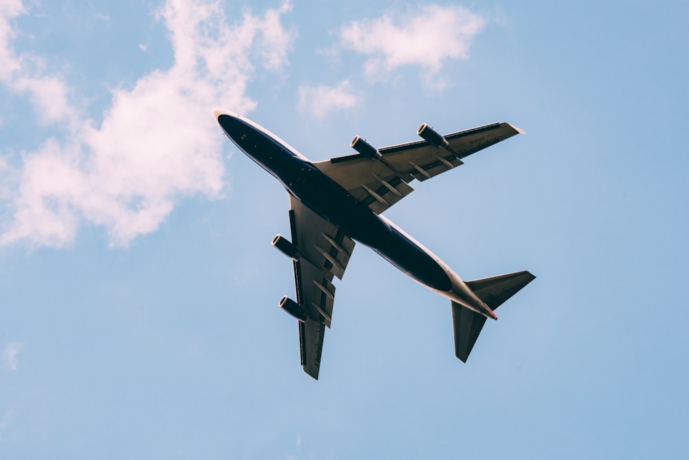 low angle photography of airplane on the sky