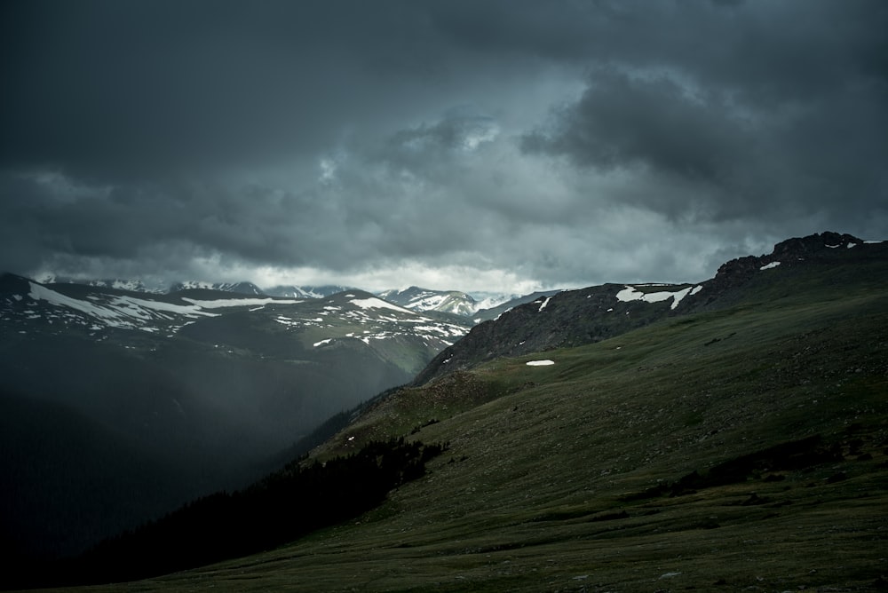 green mountain under cloudy sky